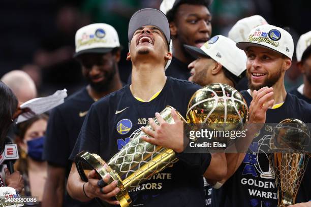 Jordan Poole of the Golden State Warriors celebrates with the Larry O'Brien Championship Trophy after defeating the Boston Celtics 103-90 in Game Six...