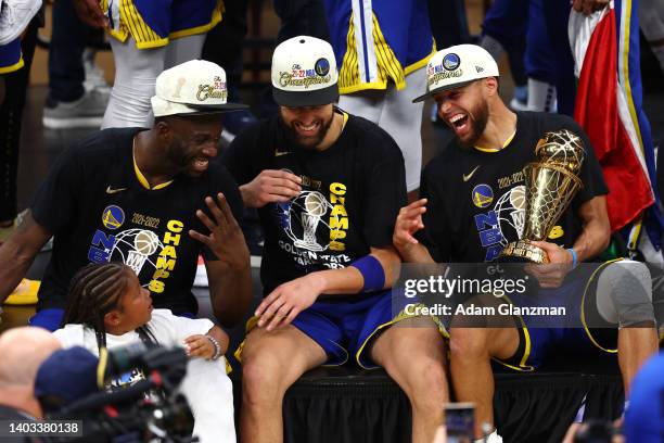 Draymond Green, Klay Thompson and Stephen Curry of the Golden State Warriors laugh together after defeating the Boston Celtics 103-90 in Game Six of...