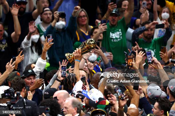 Stephen Curry of the Golden State Warriors celebrates with the Bill Russell NBA Finals Most Valuable Player Award after defeating the Boston Celtics...