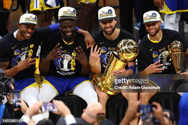 Andre Iguodala, Draymond Green, Klay Thompson and Stephen Curry of the Golden State Warriors pose for a photo after defeating the Boston Celtics...