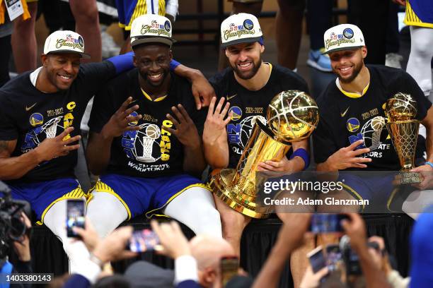 Andre Iguodala, Draymond Green, Klay Thompson and Stephen Curry of the Golden State Warriors pose for a photo after defeating the Boston Celtics...