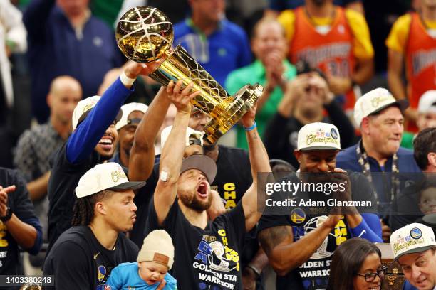 Stephen Curry of the Golden State Warriors raises the Larry O'Brien Championship Trophy after defeating the Boston Celtics 103-90 in Game Six of the...