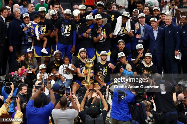 The Golden State Warriors pose for a photo after defeating the Boston Celtics 103-90 in Game Six to win the 2022 NBA Finals at TD Garden on June 16,...