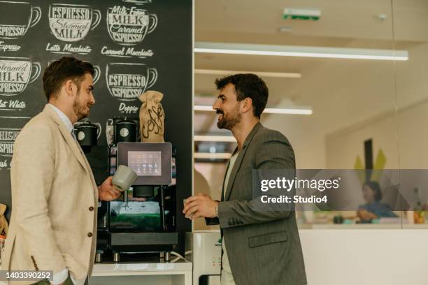 office cafeteria small talk - koffiemachine stockfoto's en -beelden