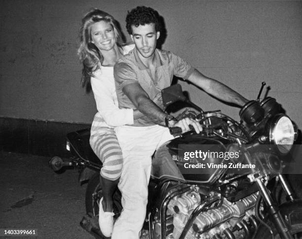 American fashion model Christie Brinkley and French racing driver Olivier Chandon de Brailles , both sitting on a Honda motorcycle, attend the 'Faces...