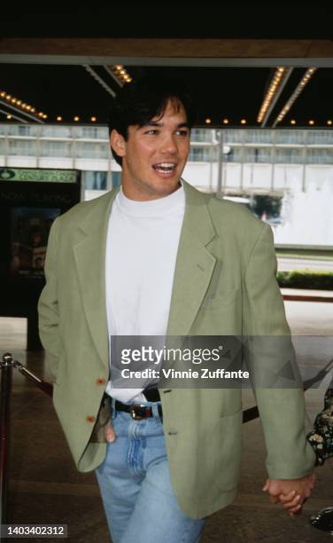 American actor Dean Cain, wearing a pale green blazer over a white t-shirt, attends the Century City premiere of 'Home Alone 2: Lost in New York,'...