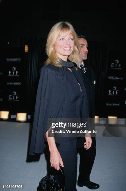 American fashion model Cheryl Tiegs, accompanied by a man, attends the Tribute to Style Millennium Exhibition and Concert, held on Rodeo Drive in...