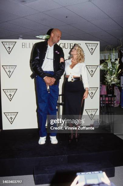 American former basketball player Kareem Abdul-Jabbar and American glamour model and actress Anna Nicole Smith during an in-store appearance for...