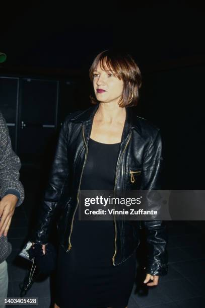 American actress Ellen Barkin, wearing a black leather jacket, attends the Hollywood premiere of 'Ed Wood,' held at the Galaxy Theatre in Los...