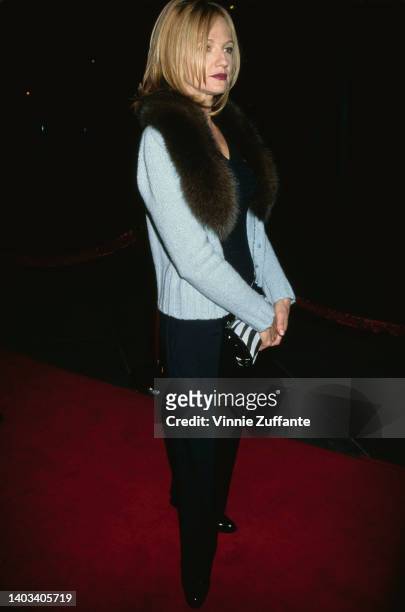 American actress Ellen Barkin, wearing a pale blue jacket with a fur collar, attends tghe Century City premiere of 'Seven Years in Tibet,' held at...