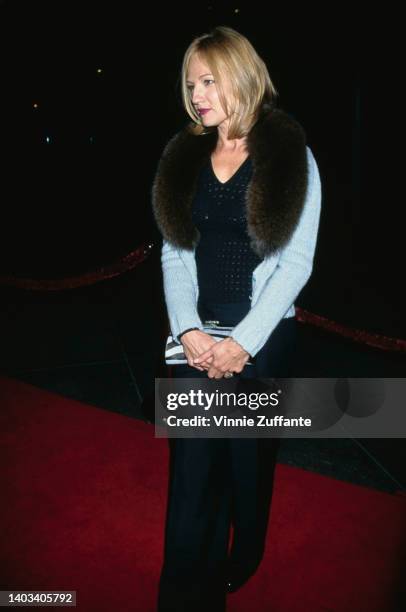 American actress Ellen Barkin, wearing a pale blue jacket with a fur collar, attends tghe Century City premiere of 'Seven Years in Tibet,' held at...