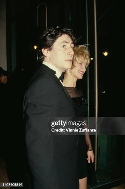 Irish actor Gabriel Byrne, wearing a tuxedo, and his wife, American actress Ellen Barkin, wearing a black outfit with sheer sleeves, attend the 49th...