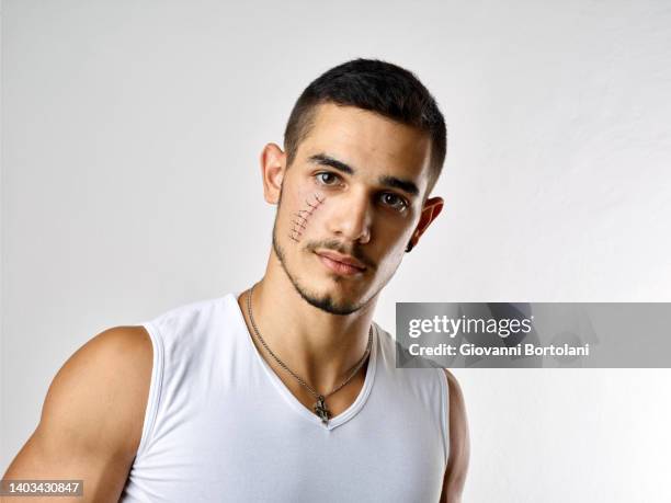 portrait of young man with wound on his face - guy with scar stock pictures, royalty-free photos & images