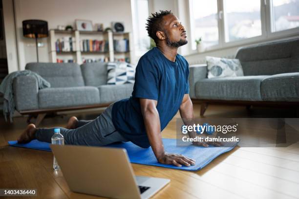 man exercising at home - home workout stock pictures, royalty-free photos & images