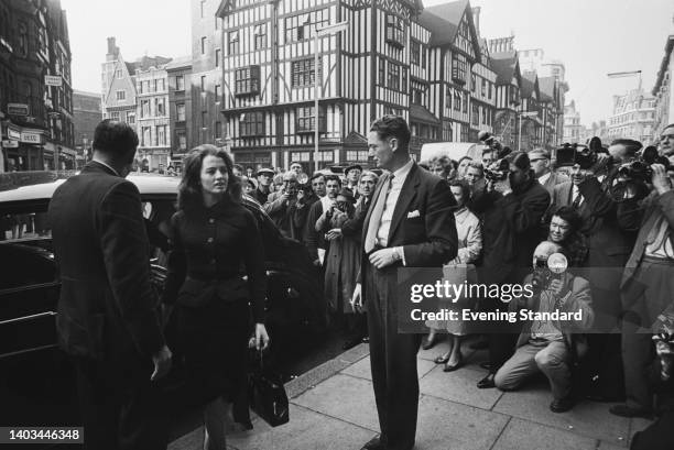 Press photographers gather as British model and showgirl Christine Keeler arrives at Marlborough Street Magistrates Court, where she is on trial for...