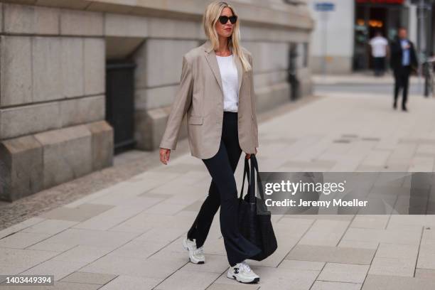 Vanessa Gieser seen wearing a black sunglasses from Celine, a white raffle blouse shirt, a beige oversize blazer from SoSue, a black slit leggings...