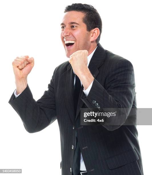 caucasian male business person standing in front of white background wearing businesswear - punching the air stock pictures, royalty-free photos & images