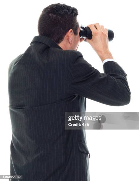 caucasian male manager standing in front of white background wearing businesswear and holding binoculars - looking around on white background stock pictures, royalty-free photos & images