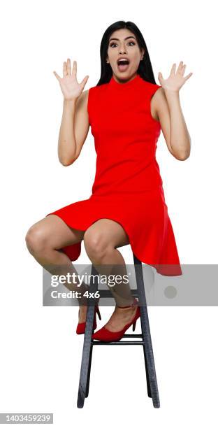 latin american and hispanic ethnicity young women resting in front of white background wearing dress - latin beauty stockfoto's en -beelden