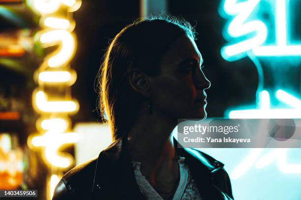 woman silhouette against neon signs at night - photo exhibition stock pictures, royalty-free photos & images