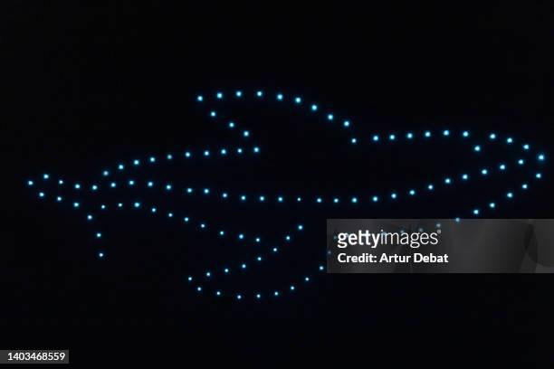 drone show iluminating the sky of barcelona city with a whale shape. - world it show stock-fotos und bilder