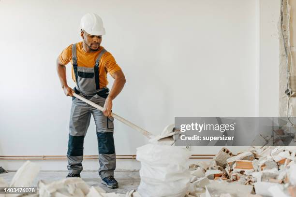 cleaning up the residue - house rubble stock pictures, royalty-free photos & images