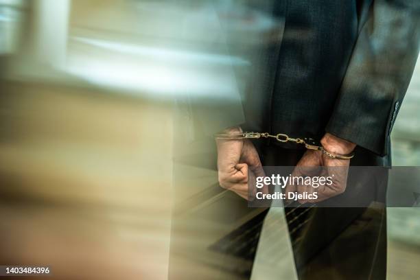 handcuffed businessman getting arrested. - 被捕 個照片及圖片檔