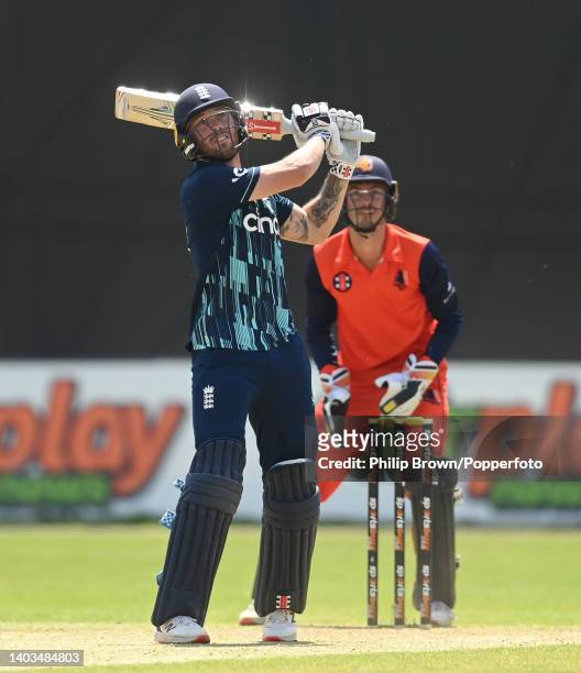Phil Salt of England hits a six watched by Scott Edwards during the first One Day International between Netherlands and England at VRA Cricket Ground...