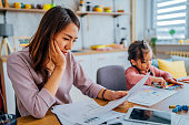 Stressed mother going through her finances
