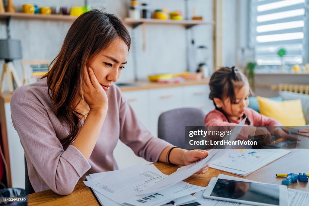 Stressed mother going through her finances