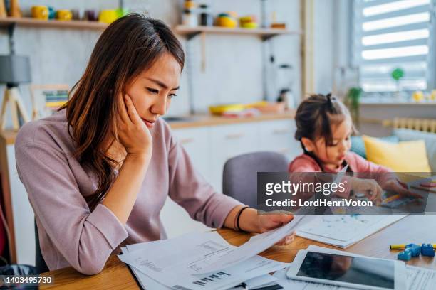 stressed mother going through her finances - home finances bildbanksfoton och bilder