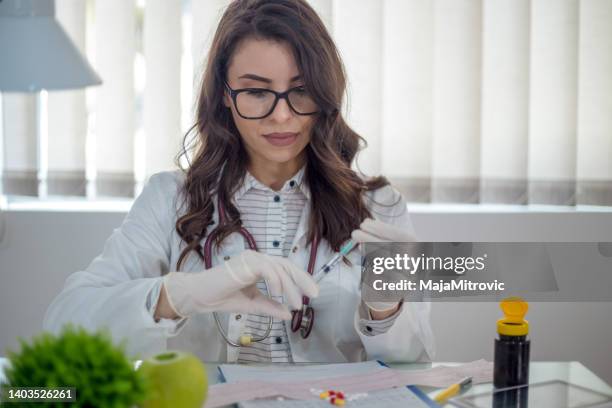 doctor, researcher or scientist hand in glove holding flu, measles, rubella or hpv vaccine and syringe with needle vaccination for baby, child, woman or man shot, medicine vial dose injection - measles hand stock pictures, royalty-free photos & images