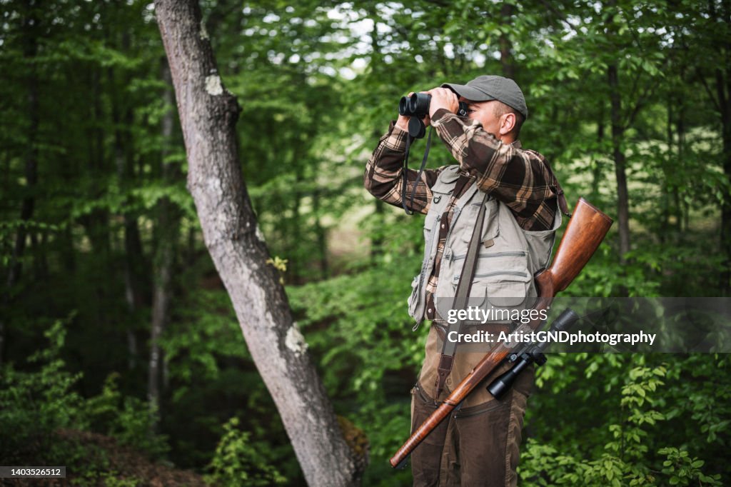 Hunter looking through his binoculars.