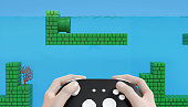 Hand hold game controller with arcade video game background 3D render illustration