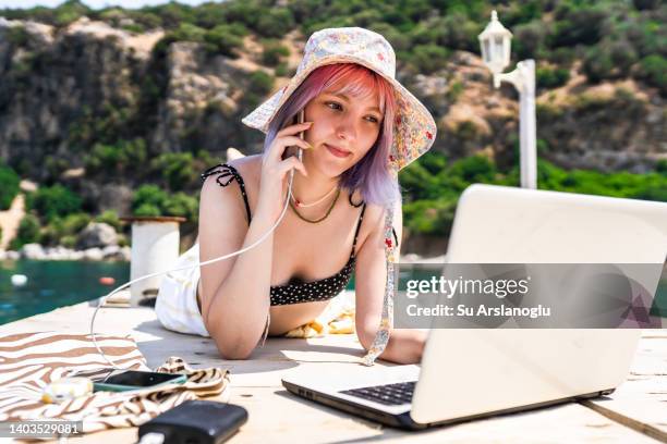 young woman with colored hair working remotely on vacation - gen z work stock pictures, royalty-free photos & images