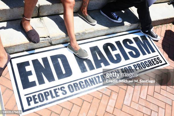 An "End Racism" sign is seen on the floor during a Juneteenth reparations rally at Newark City Hall on June 17, 2022 in Newark, New Jersey. The New...