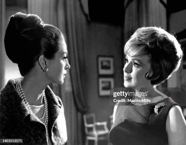 In this handout photo, Actress Capucine and American comedienne, actress, singer and businesswoman Edie Adams film a scene during the movie "The...