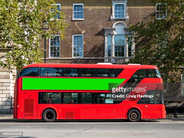 close up of city center bus transport vehicle on street with green screen chroma key marketing advertisement billboard on side that can be replaced with marketing or ad agencies campaign content targeting adverts at consumers, retail shoppers, commuters - london buses stock-fotos und bilder