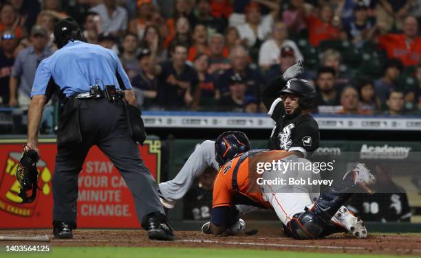 Leury Garcia of the Chicago White Sox is tagged out by Martin Maldonado of the Houston Astros in the fourth inning at Minute Maid Park on June 17,...