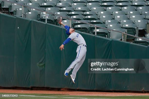 Kyle Isbel of the Kansas City Royals catches a fly ball in foul territory hit by Chad Pinder of the Oakland Athletics in the bottom of the first...