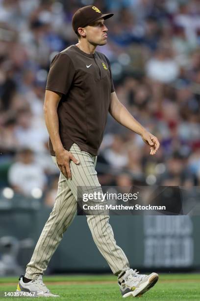 Acting Manager Ryan Flaherty of the San Diego Padres walks to the mound to change pitchers against the Colorado Rockies in the fifth inning at Coors...