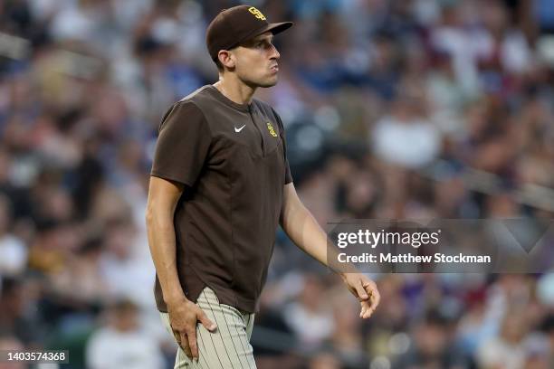 Acting Manager Ryan Flaherty of the San Diego Padres walks to the mound to change pitchers against the Colorado Rockies in the fifth inning at Coors...