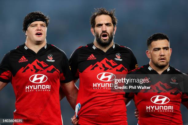 To R, Scott Barrett, Sam Whitelock, and Codie Taylor of the Crusaders sing the national anthem during the 2022 Super Rugby Pacific Final match...
