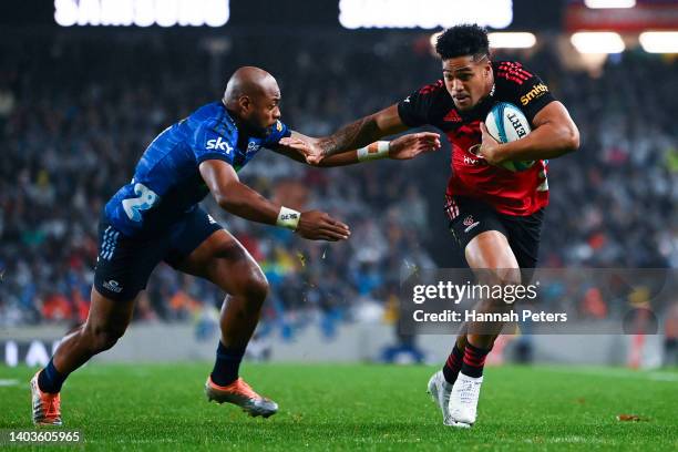 Leicester Fainga'anuku of the Crusaders attempts to evade Mark Telea of the Blues during the 2022 Super Rugby Pacific Final match between the Blues...