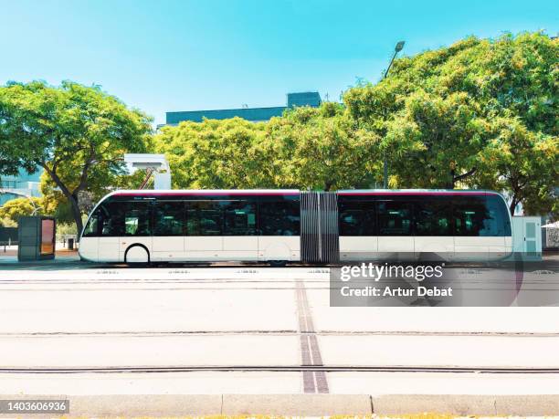 electric ecologic bus in the streets of barcelona city. - bus road stock-fotos und bilder