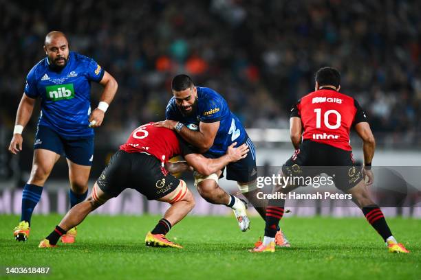 Akira Ioane of the Blues is tackled by Pablo Matera of the Crusaders during the 2022 Super Rugby Pacific Final match between the Blues and the...