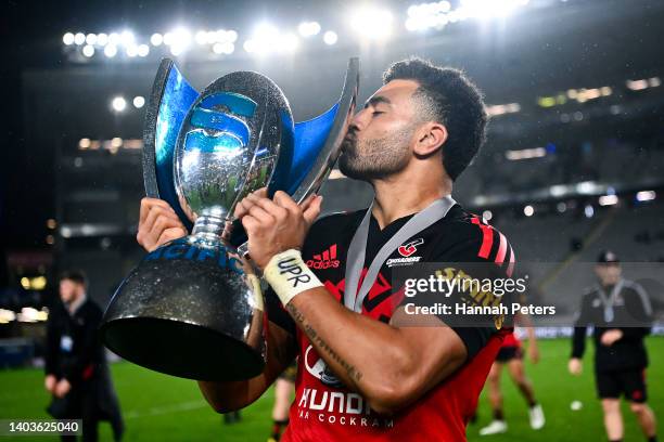 Richie Mo'unga of the Crusaders kisses the Super Rugby Pacific trophy after winning the 2022 Super Rugby Pacific Final match between the Blues and...