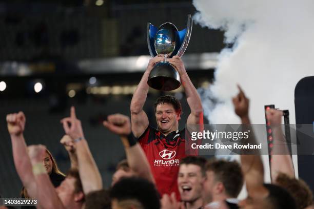 Captain Scott Barrett of the Crusaders holds the trophy up high after victory in the 2022 Super Rugby Pacific Final match between the Blues and the...