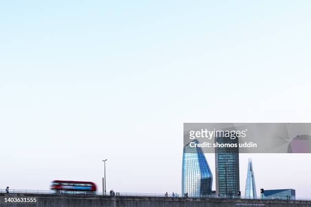 london city skyline with buses and commuters in motion - english high street stock pictures, royalty-free photos & images