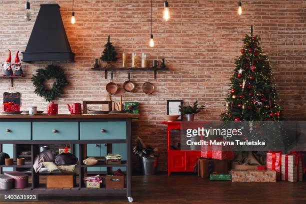 christmas kitchen decor. cooking festive food in the kitchen. new year. christmas. christmas decor. christmas tree. christmas background. christmas home interior decor. holiday. loft style kitchen. - christmas tree living room stock pictures, royalty-free photos & images